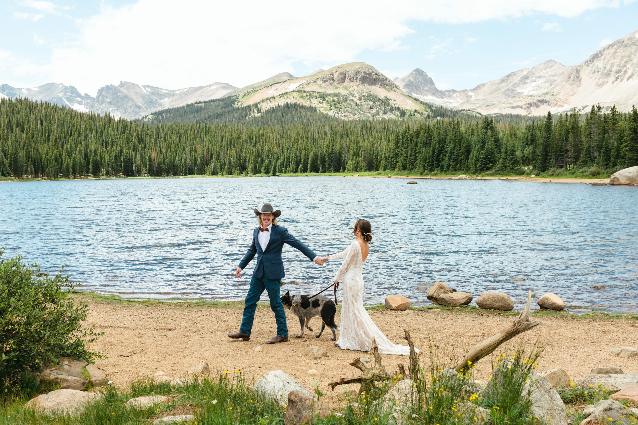 bride and groom walking with dog