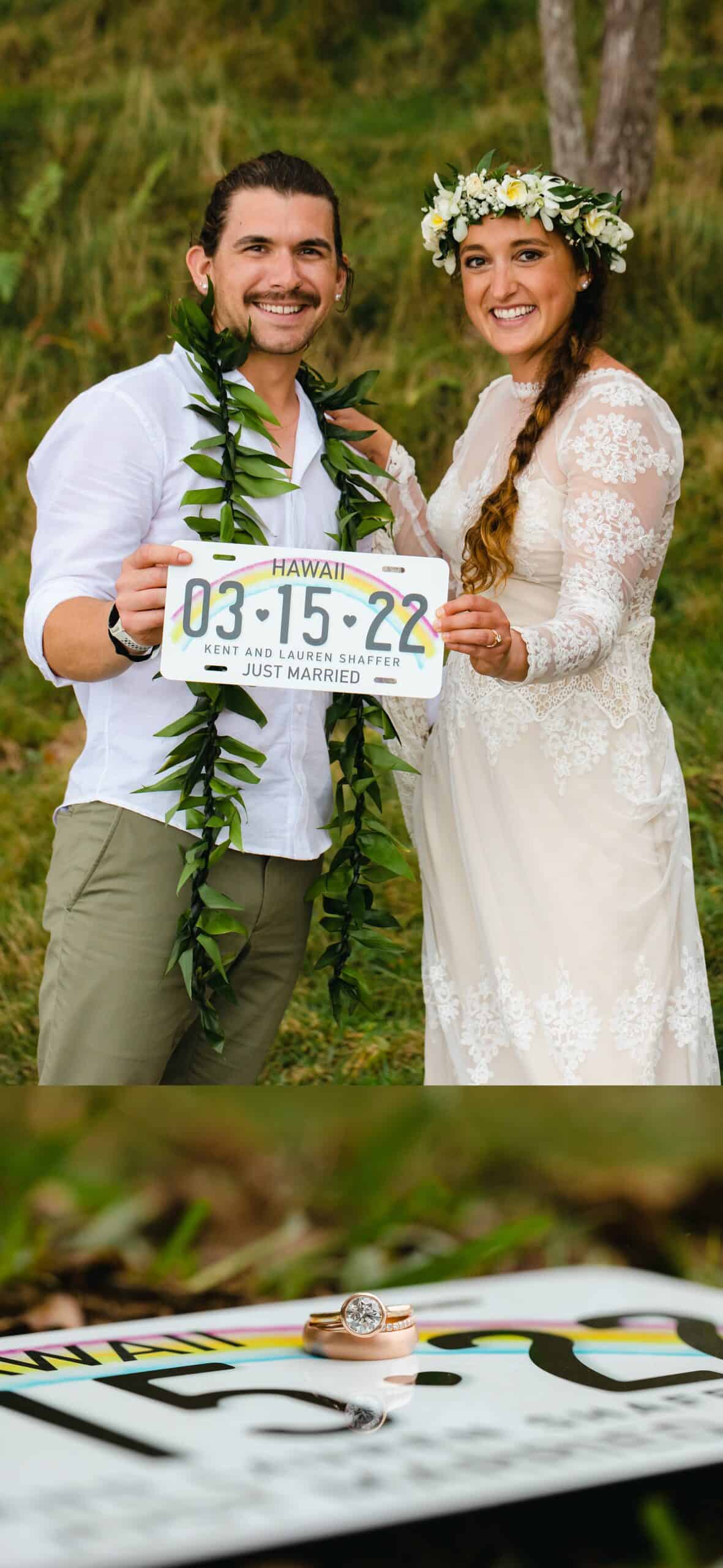 couple holding hawaii license plate 