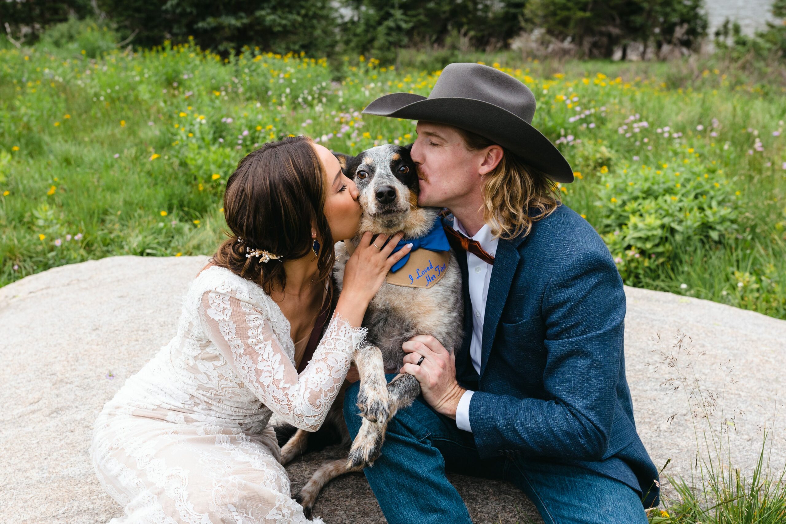 bride and groom kissing dog