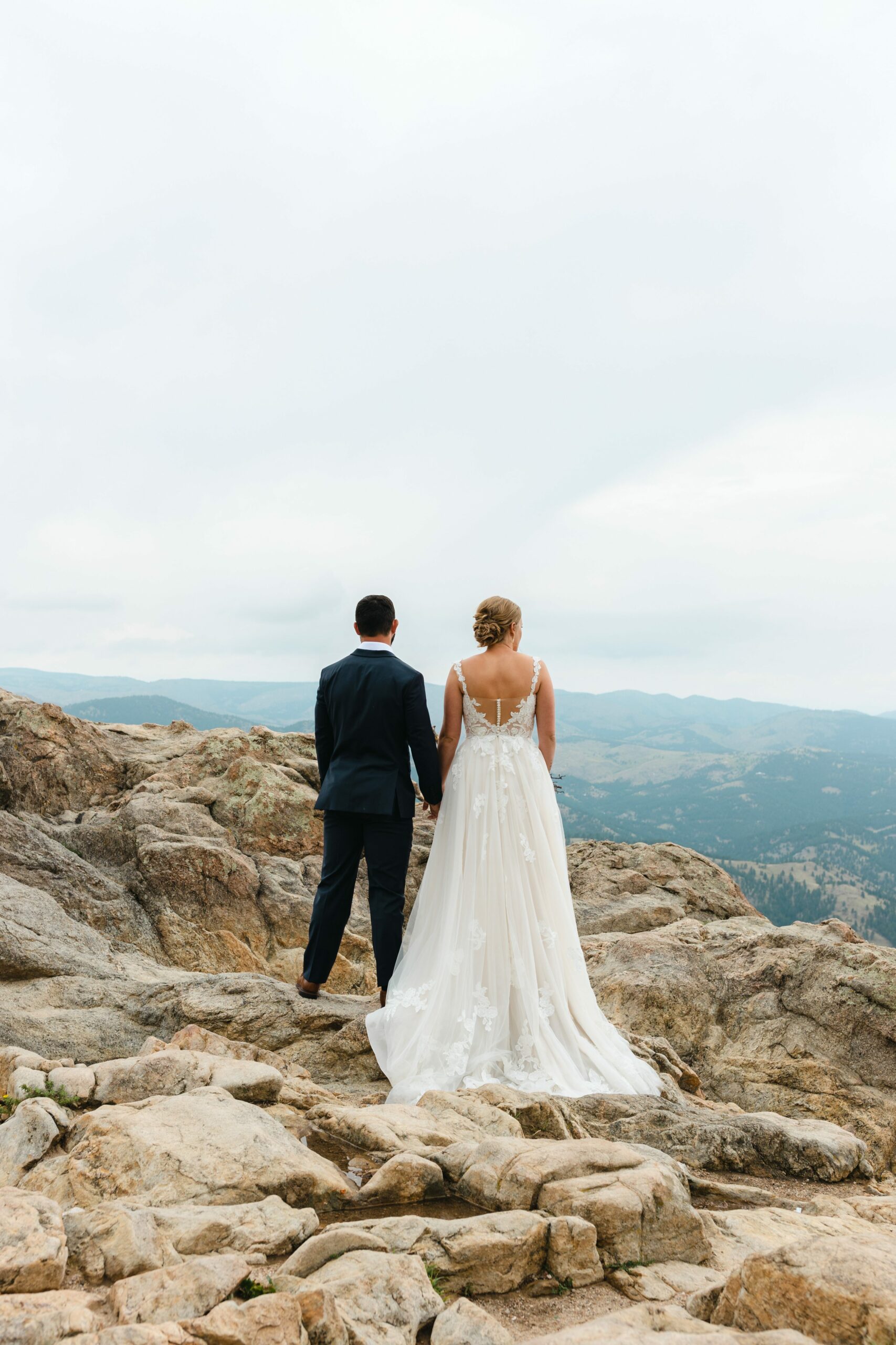 bride and groom looking out at mountain views