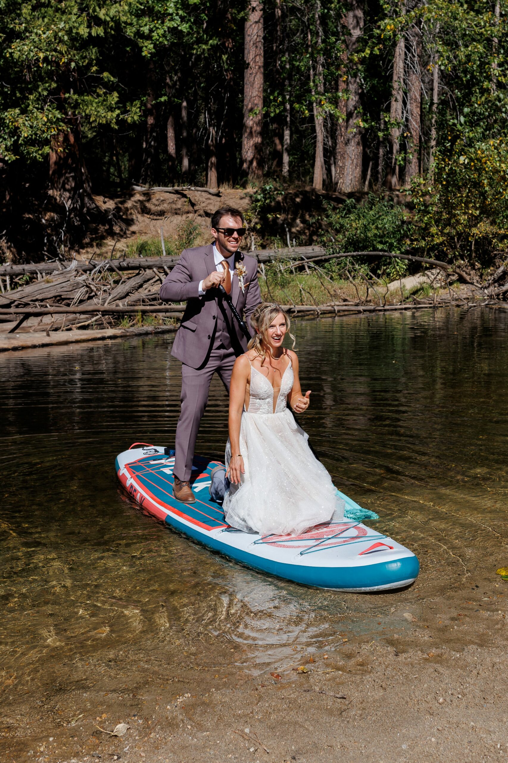 bride and groom on paddleboard